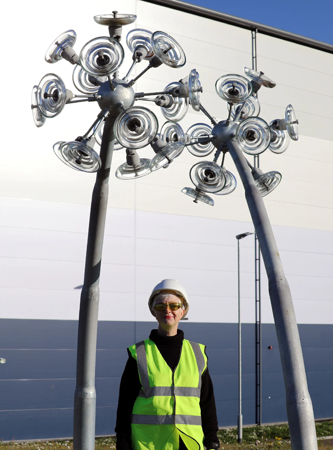 Artist Ailsa Magnus with her dandelion sculpture using reclaimed glass insulators from the transmission network Artist Ailsa Magnus with her dandelion sculpture using reclaimed glass insulators from the transmission network