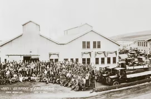 Black and white photo of staff and vehicles